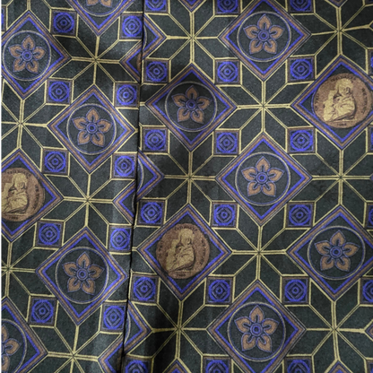 Close-up of a patterned fabric with geometric design and portraits.