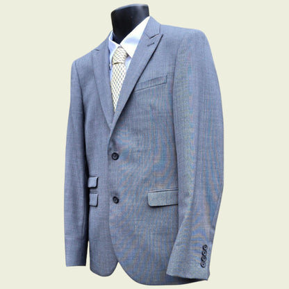Grey suit jacket on a mannequin against a light background