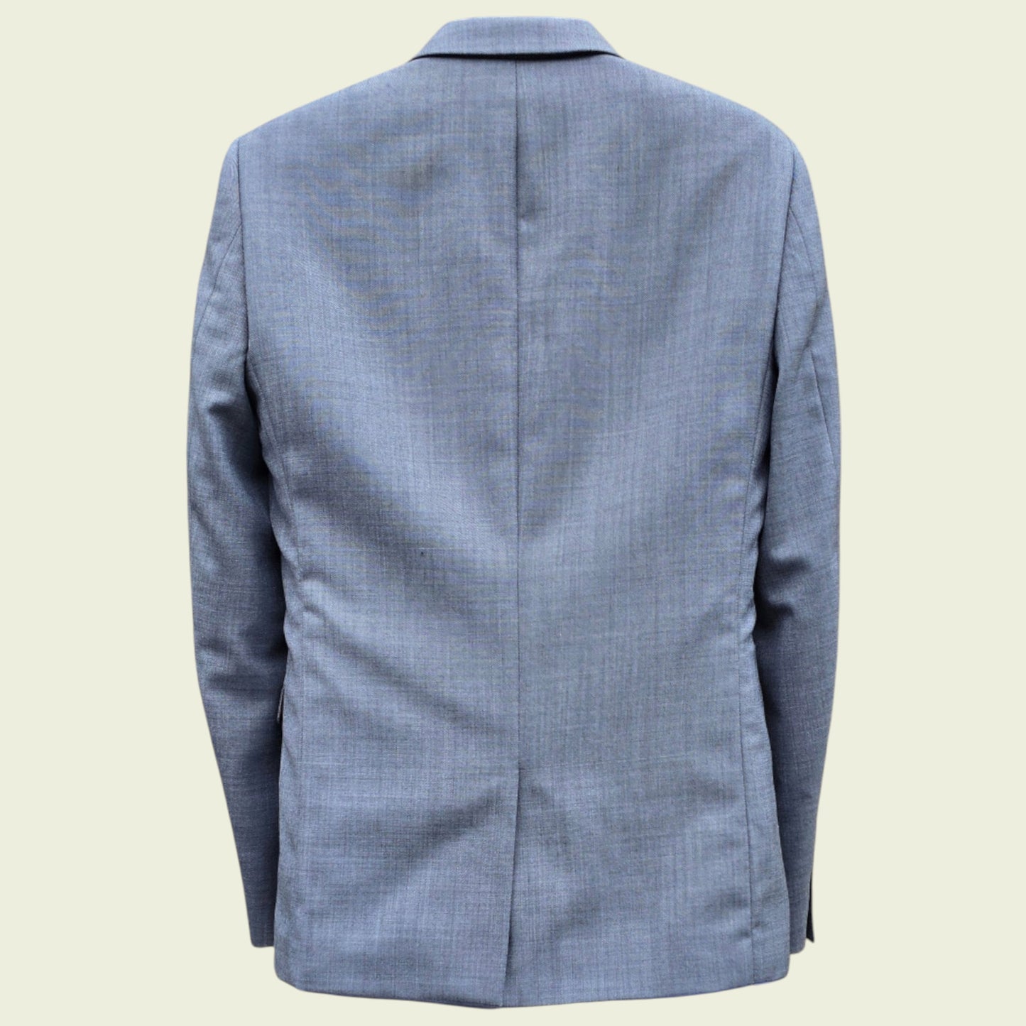 Grey checkered blazer on a beige background