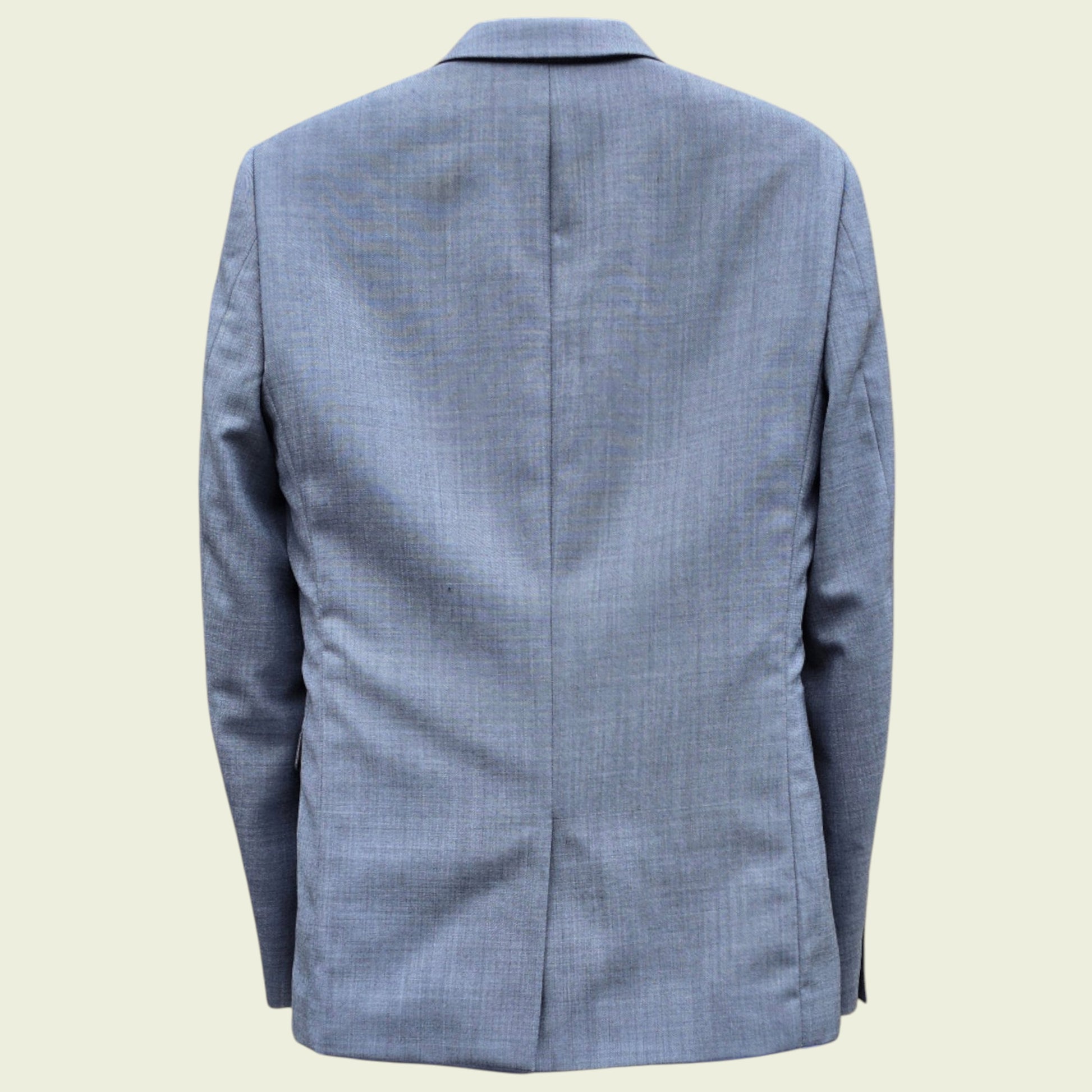 Grey checkered blazer on a beige background