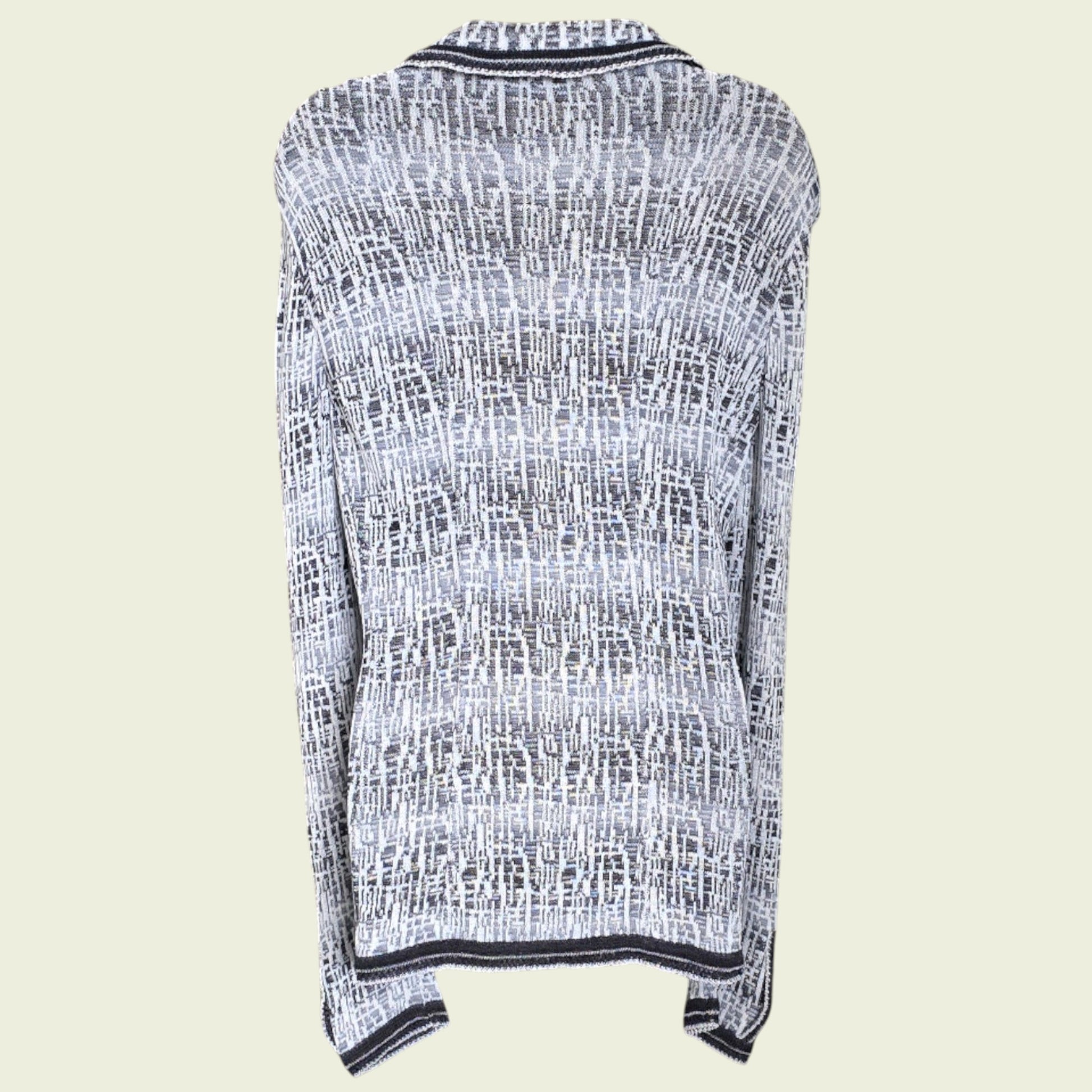 Mannequin wearing blue and white knitted jacket on a beige background