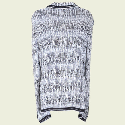 Mannequin wearing blue and white knitted jacket on a beige background