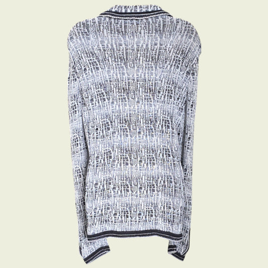 Mannequin wearing blue and white knitted jacket on a beige background