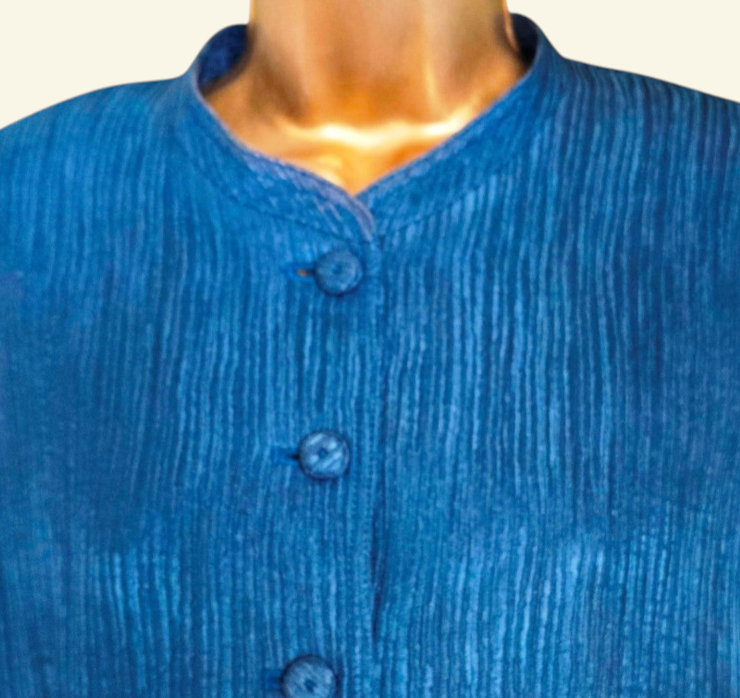 Blue textured shirt on a mannequin with a plain background