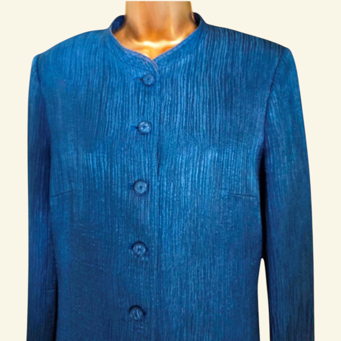 Blue textured jacket on a mannequin against a white background