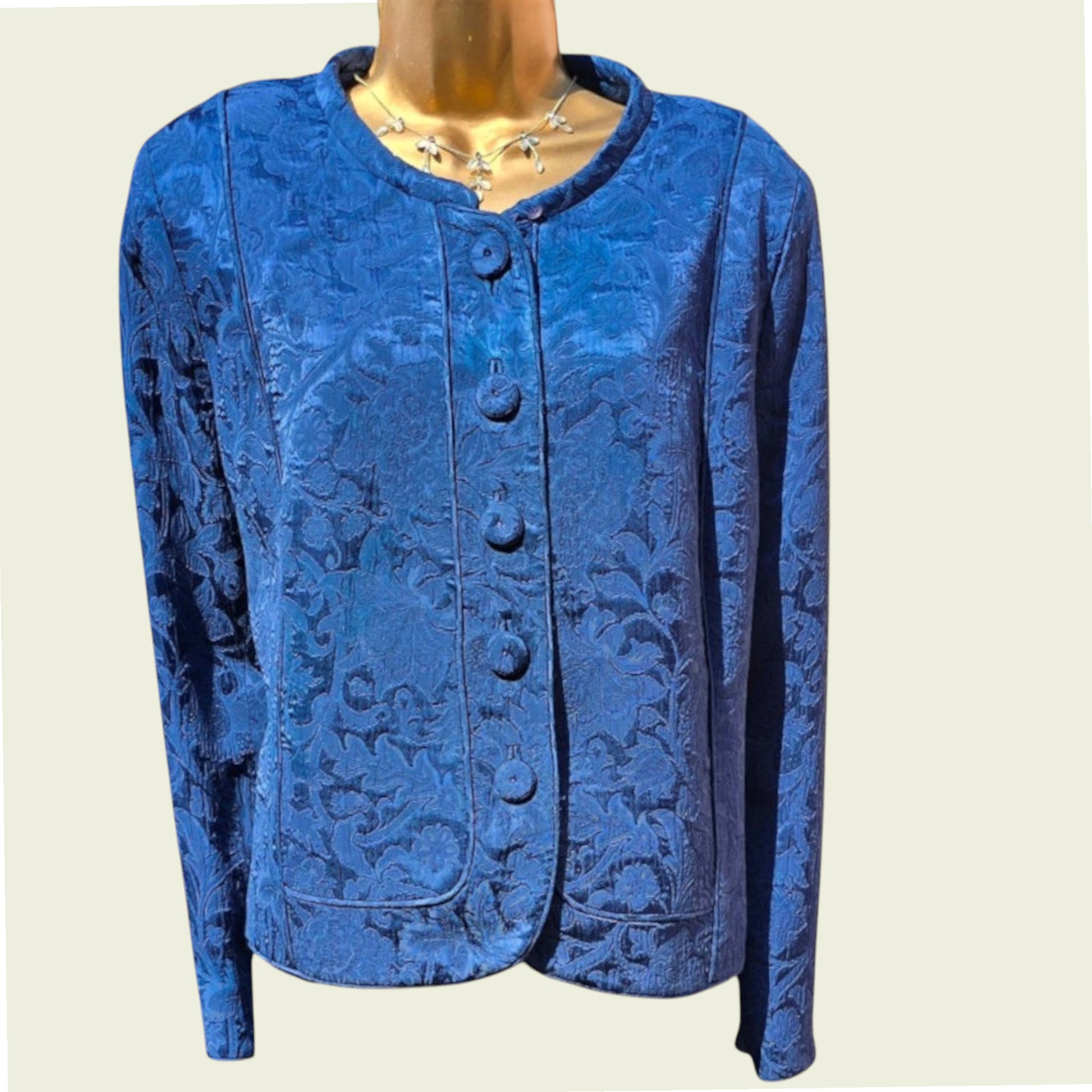 Mannequin wearing a midnight blue jacket on a beige background