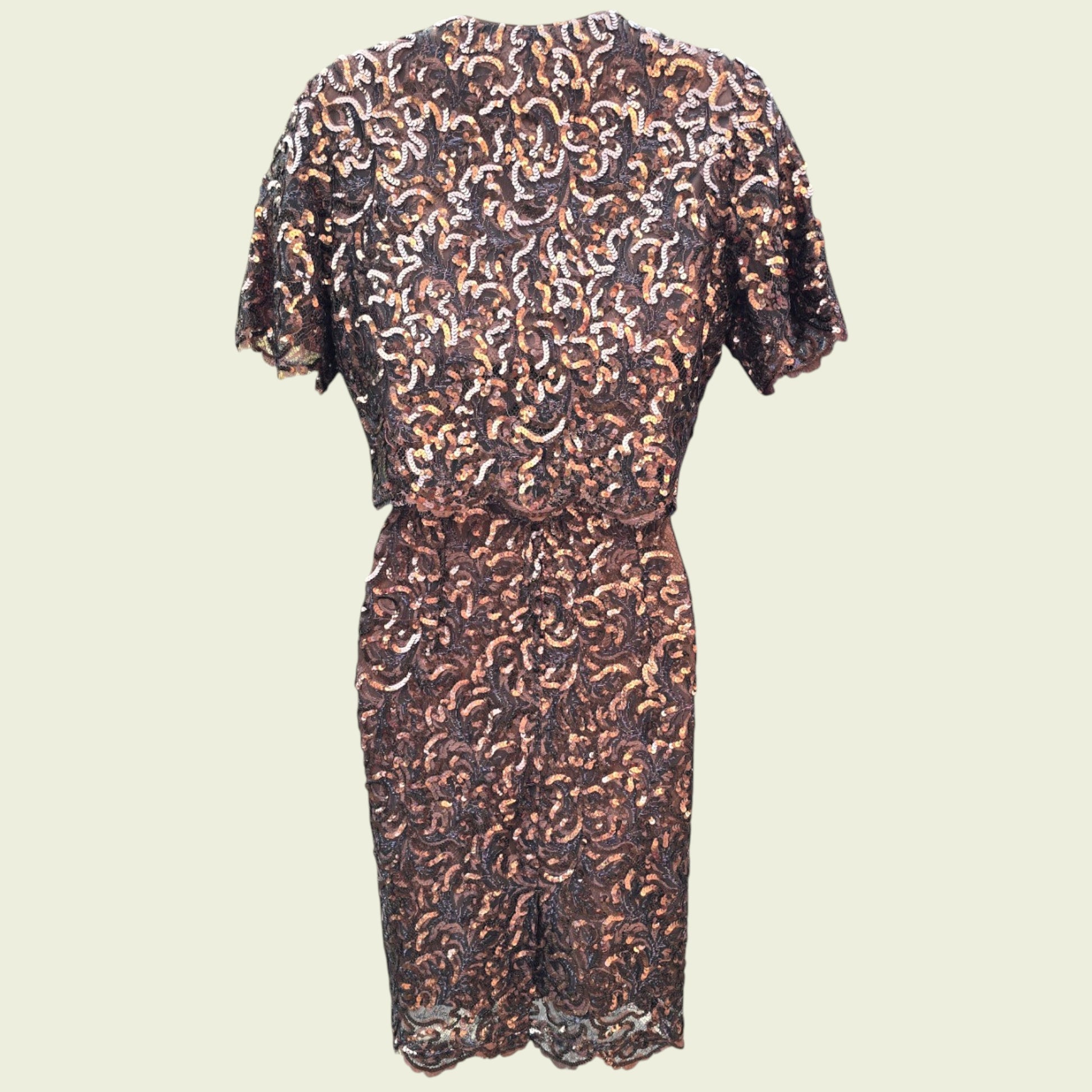 Sequinned dress and bolero on a beige background