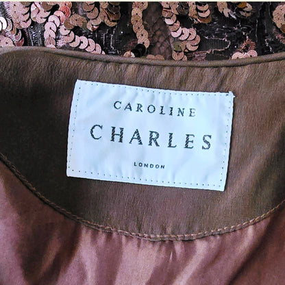 Close-up of a 'Caroline Charles London' label on a garment with sequin details.