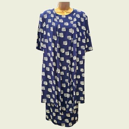 Blue dress with white geometric pattern on a mannequin against a white background