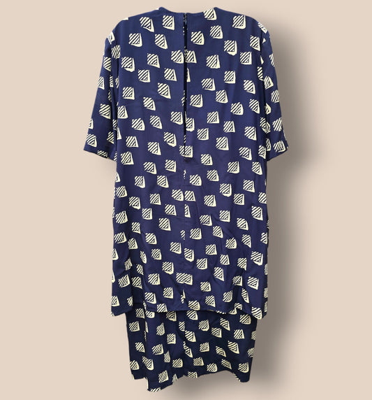 Navy blue dress with white geometric pattern on a beige background