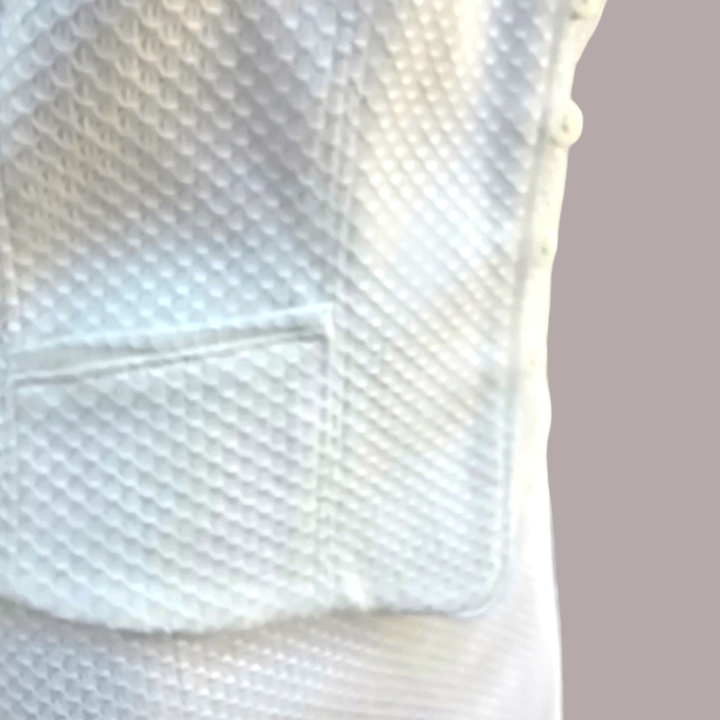 Close-up of a textured white surface with geometric patterns