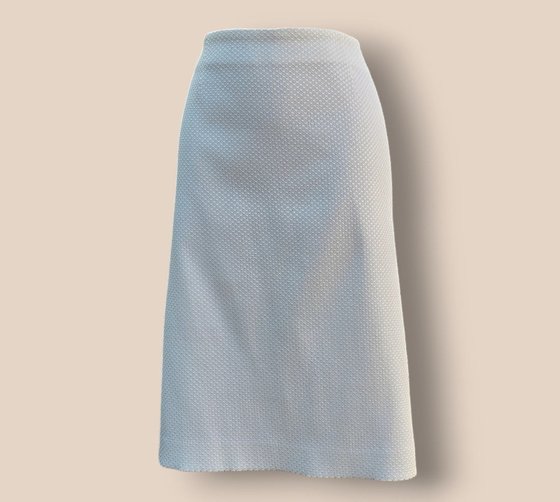 White textured skirt on a beige background