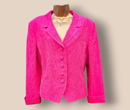 Pink textured jacket on a mannequin against a beige background