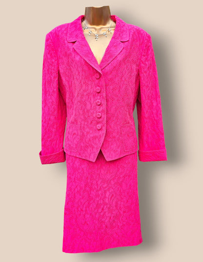 Pink suit on a mannequin against a beige background
