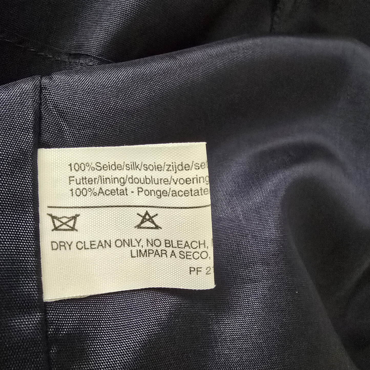 Clothing label on a dark fabric background