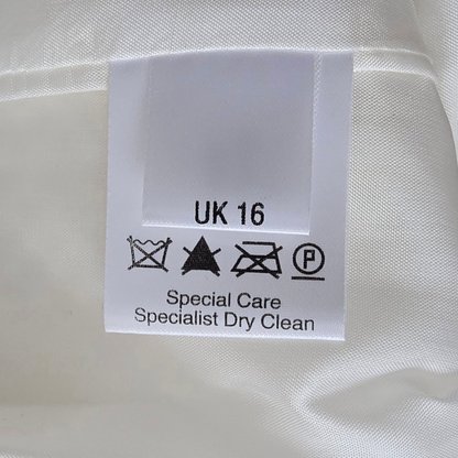 Clothing label with size 'UK 16' and care instructions on a white fabric background
