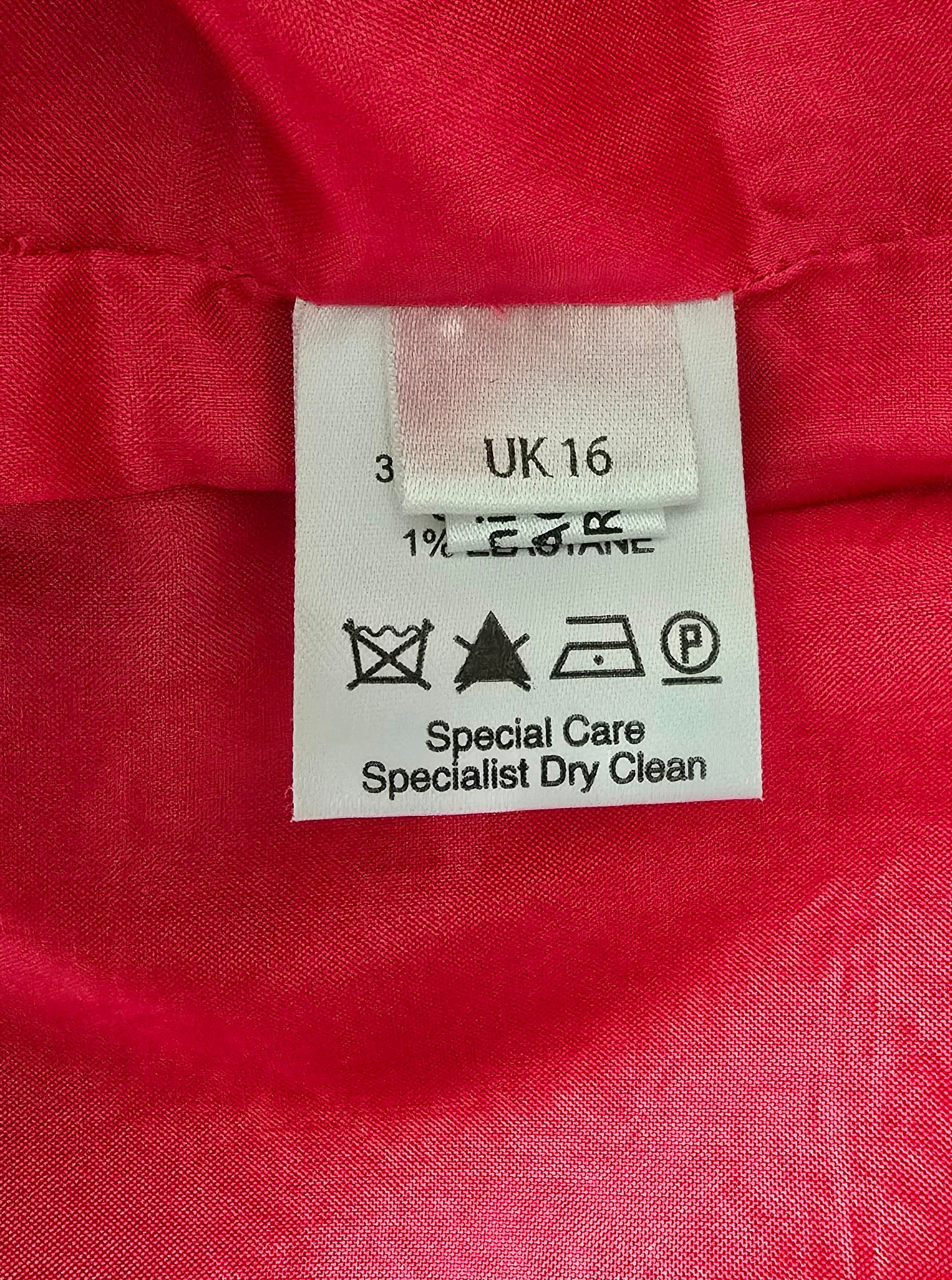 Clothing label on a red fabric background
