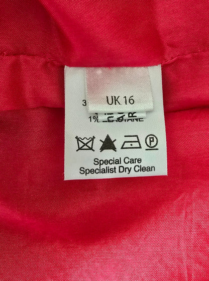 Clothing label on a red fabric background