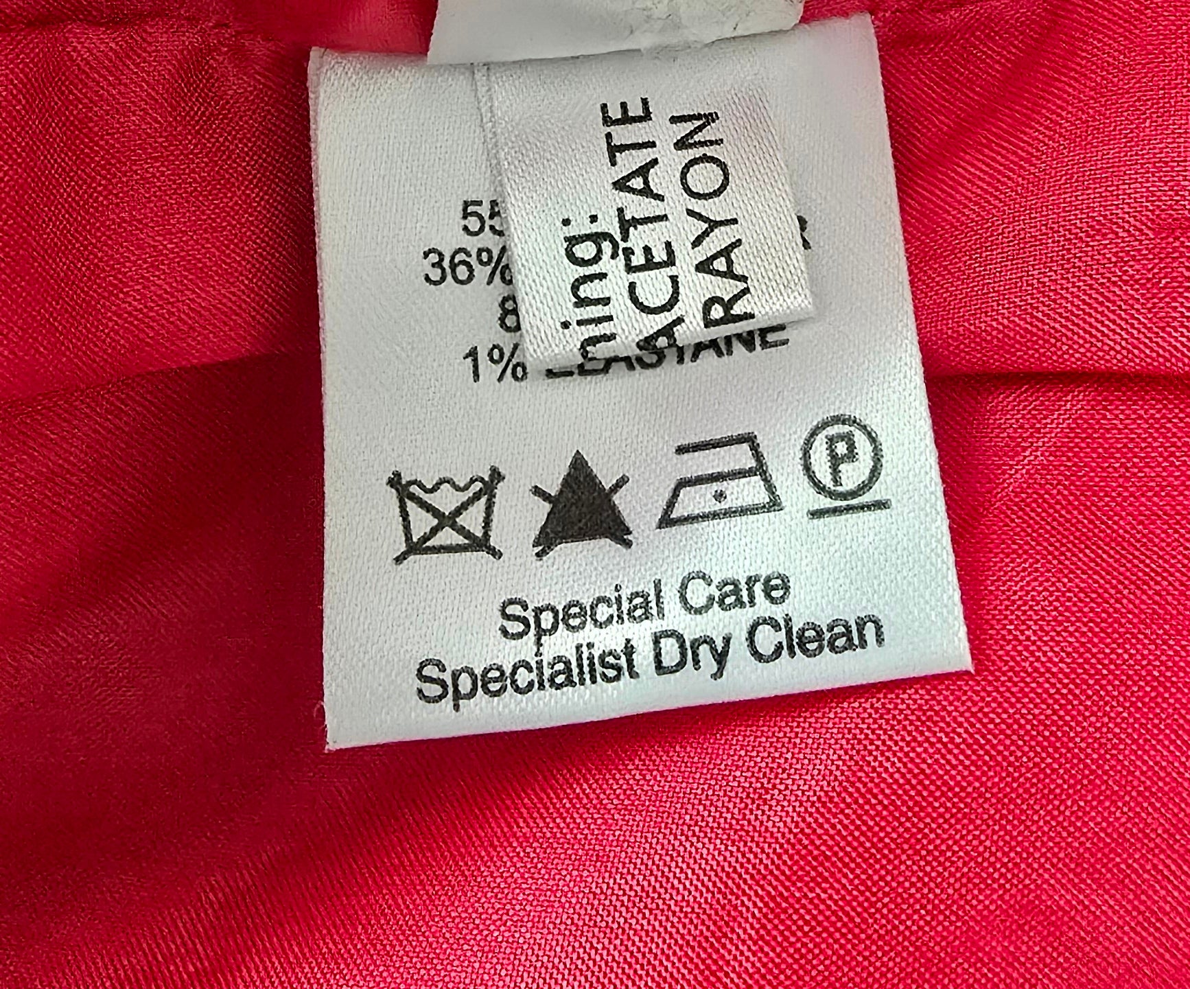 Clothing label on a red fabric background