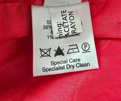 Clothing label on a red fabric background