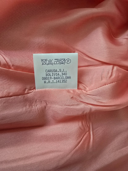 Close-up of a pink fabric with a label on it