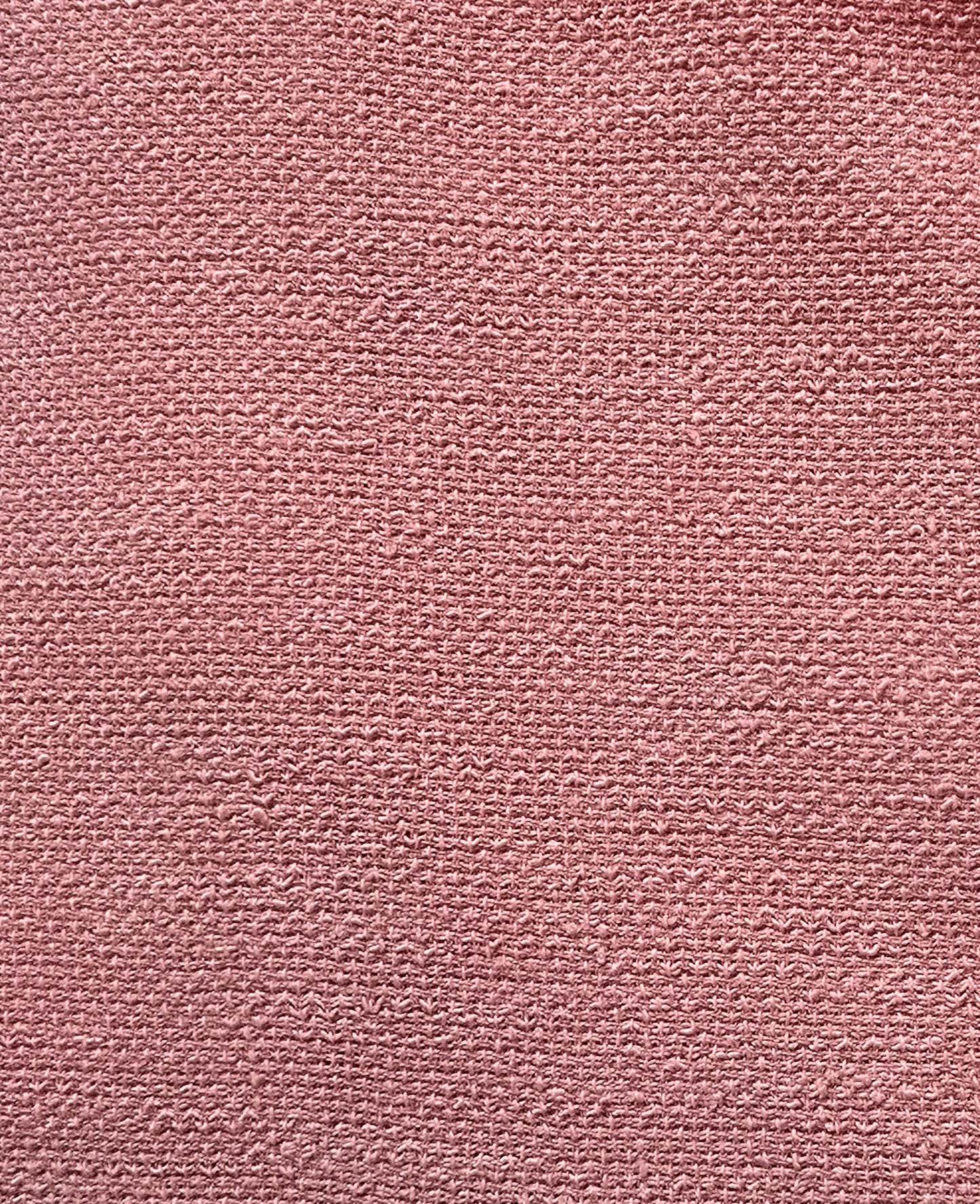 Close-up of a textured pink fabric surface
