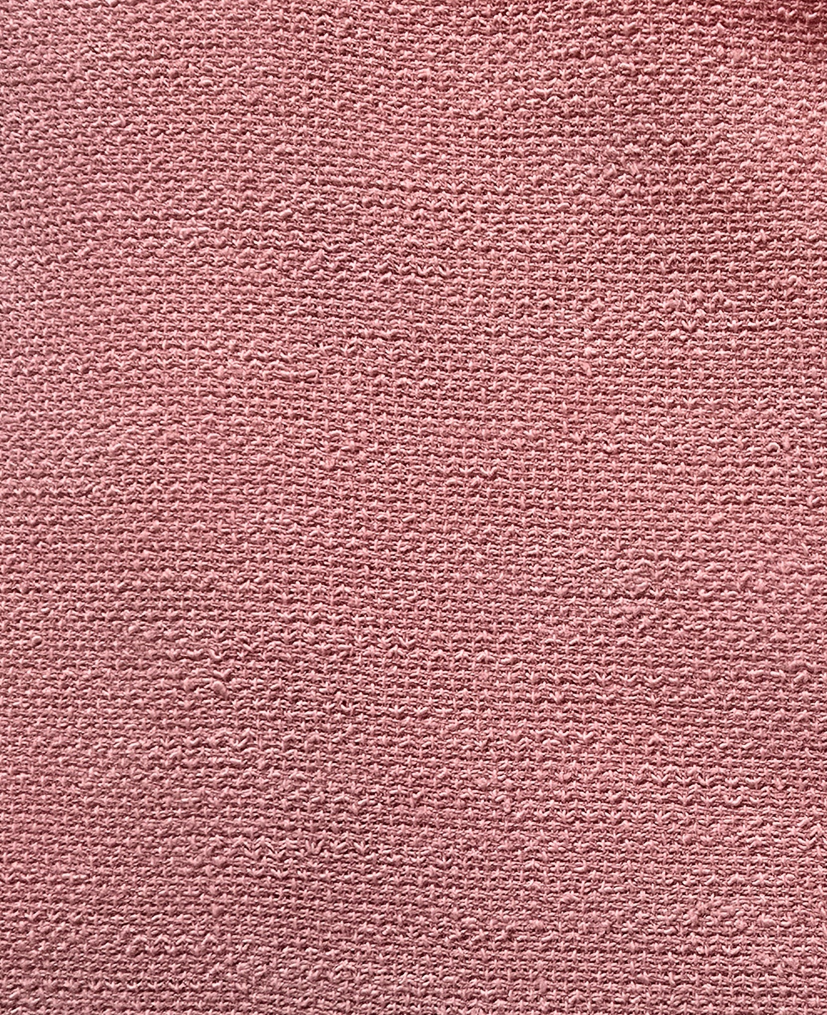 Close-up of a textured pink fabric surface