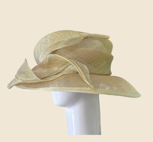 Beige straw hat on a mannequin head against a beige background
