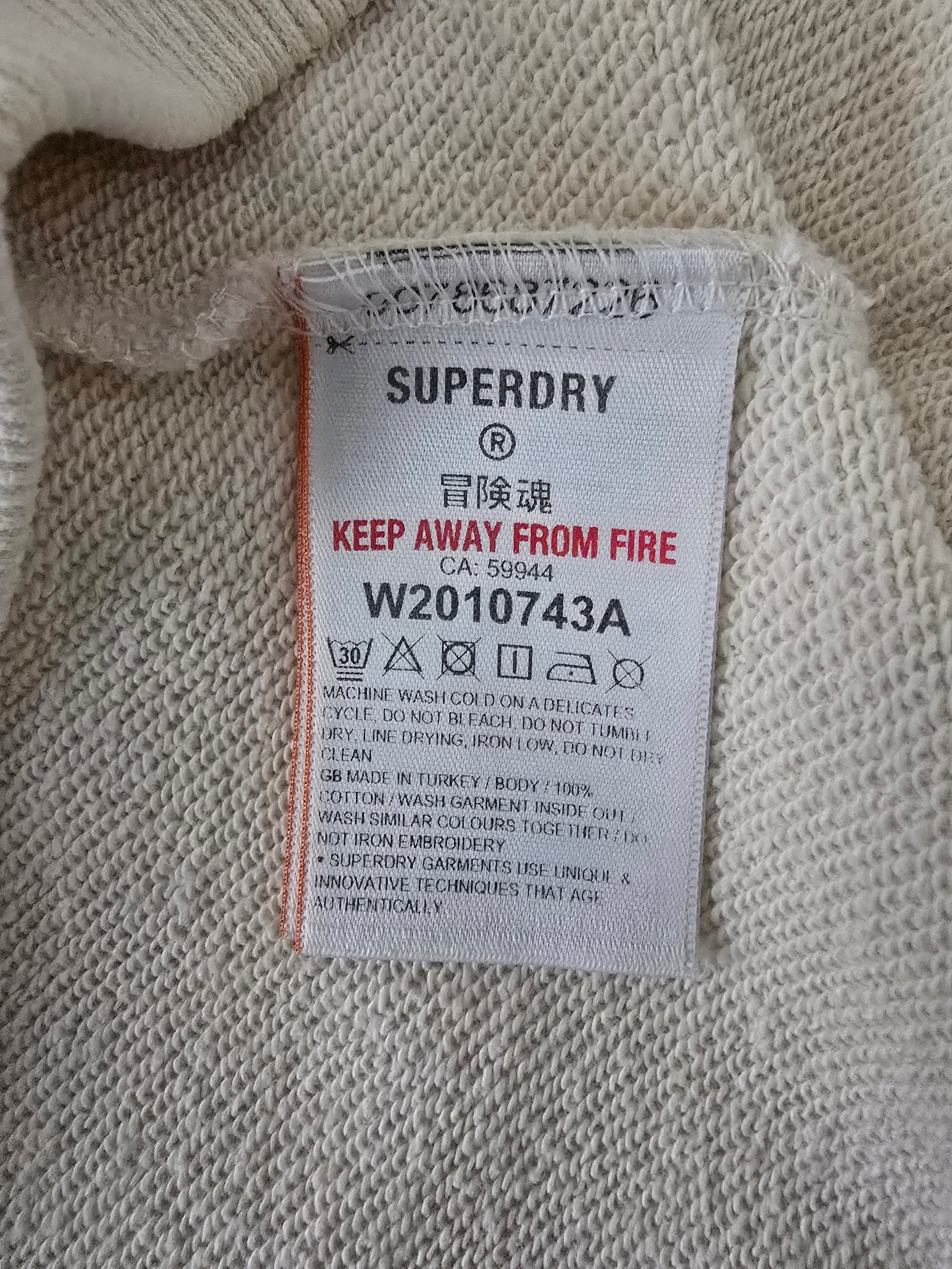 Superdry label on a textured fabric background