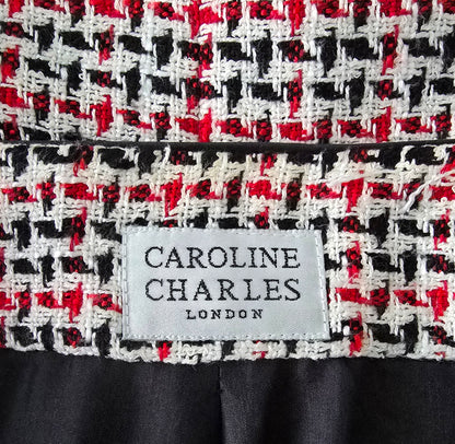 Close-up of a patterned fabric with a 'Caroline Charles London' label.