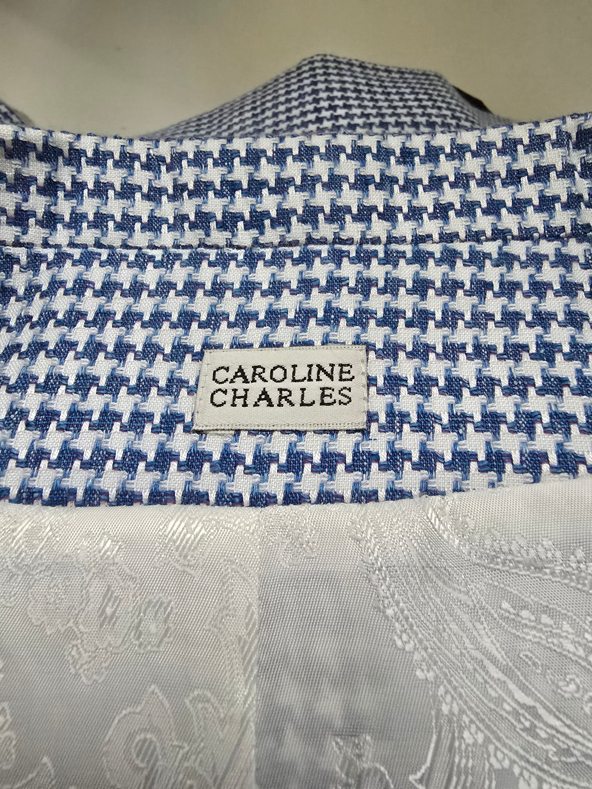 Close-up of a patterned fabric with a visible label on a neutral background