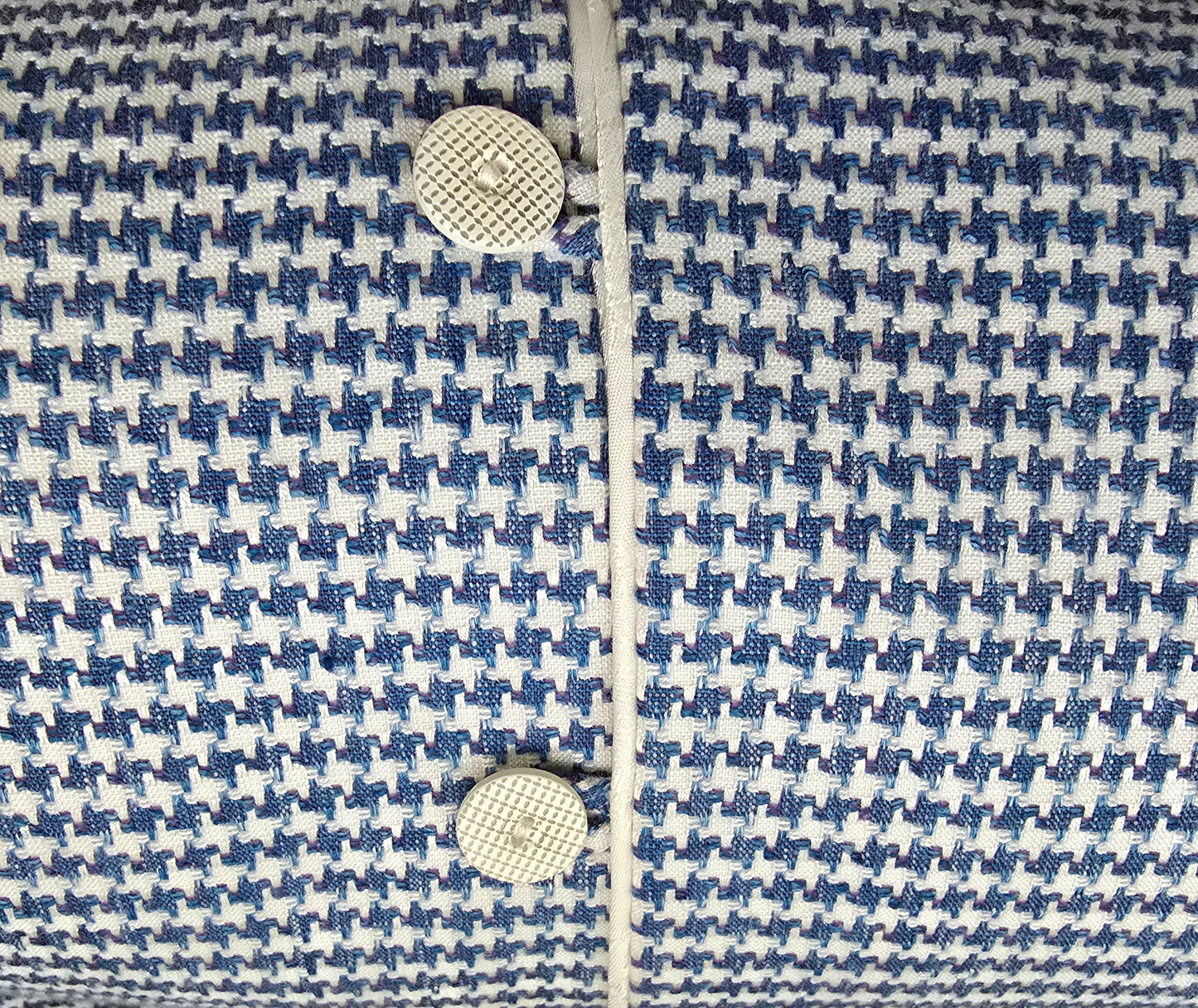 Close-up of a blue and white patterned fabric with buttons.