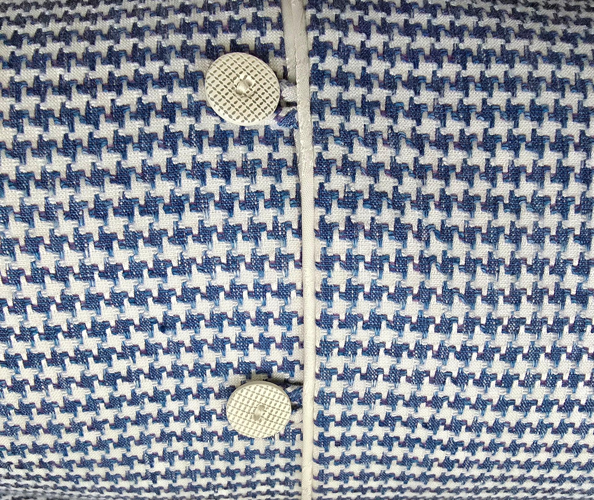 Close-up of a blue and white patterned fabric with buttons.