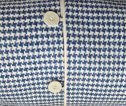Close-up of a blue and white patterned fabric with buttons.