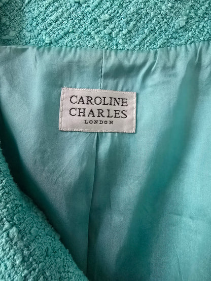 Turquoise fabric with a visible label reading 'Caroline Charles London'.