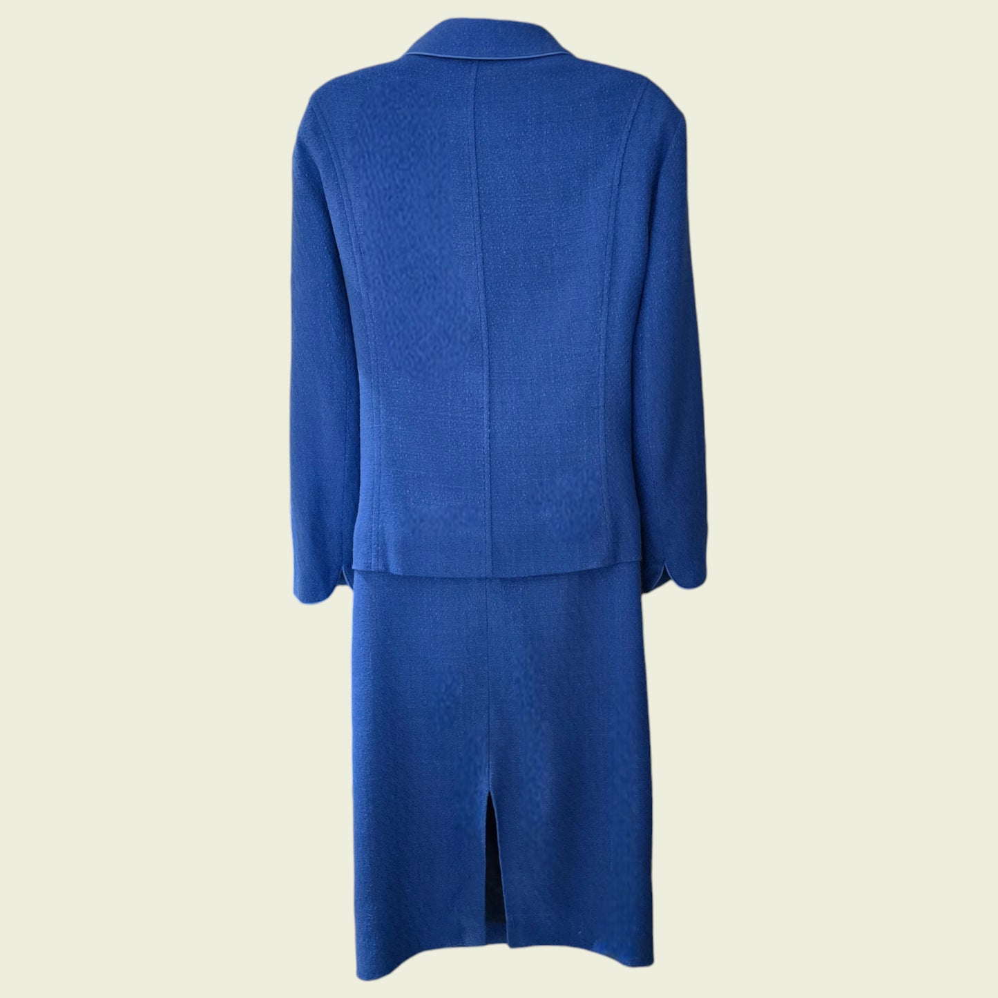 Blue suit jacket and skirt set on a beige background
