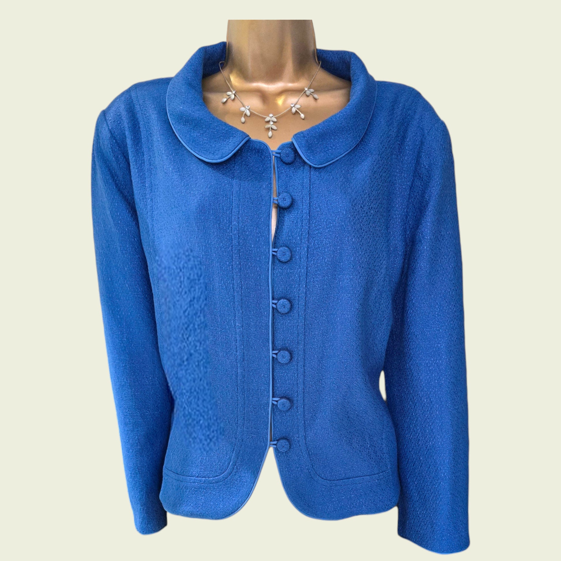 Blue jacket on a mannequin with a plain background