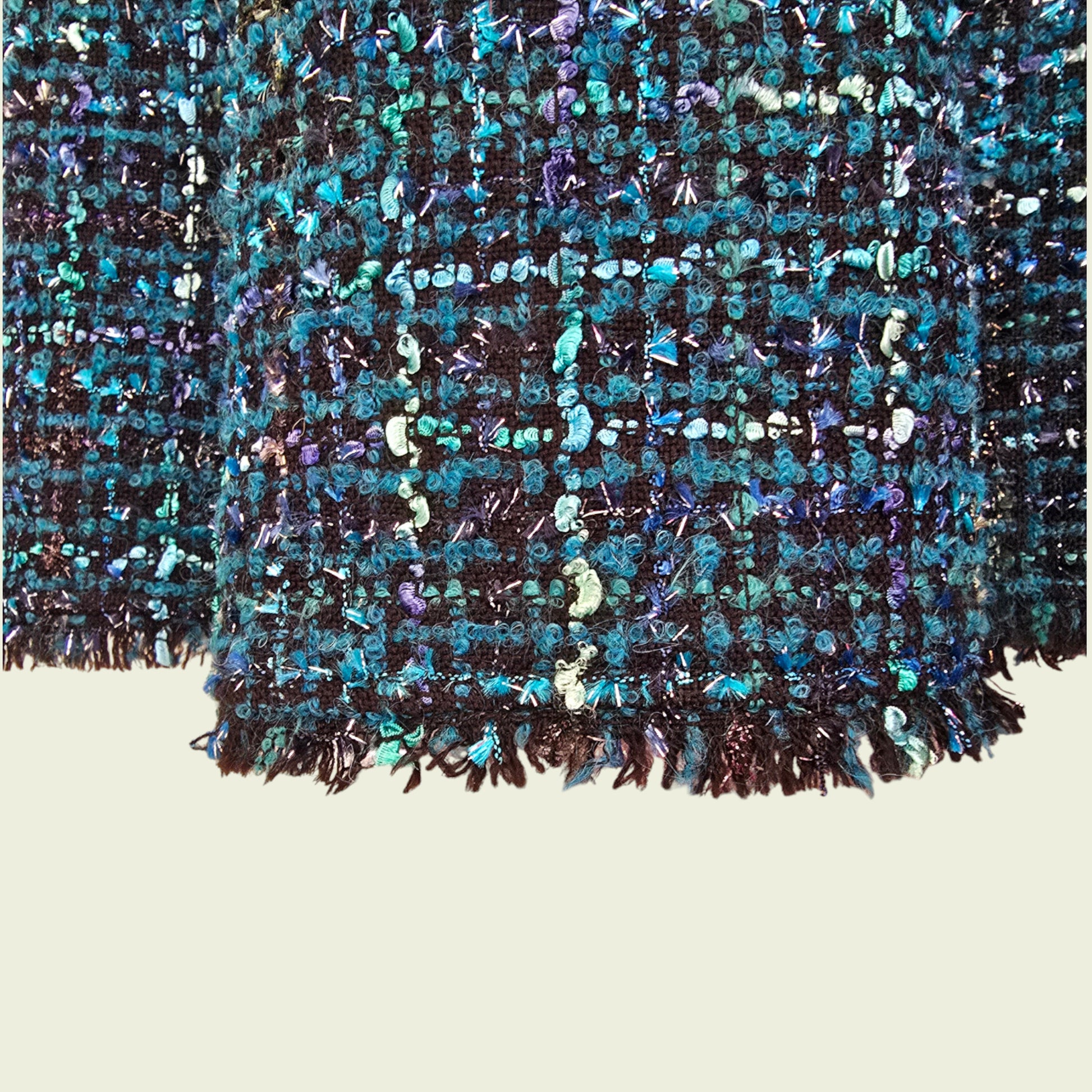 Close-up of a textured fabric with blue  pattern on a beige background