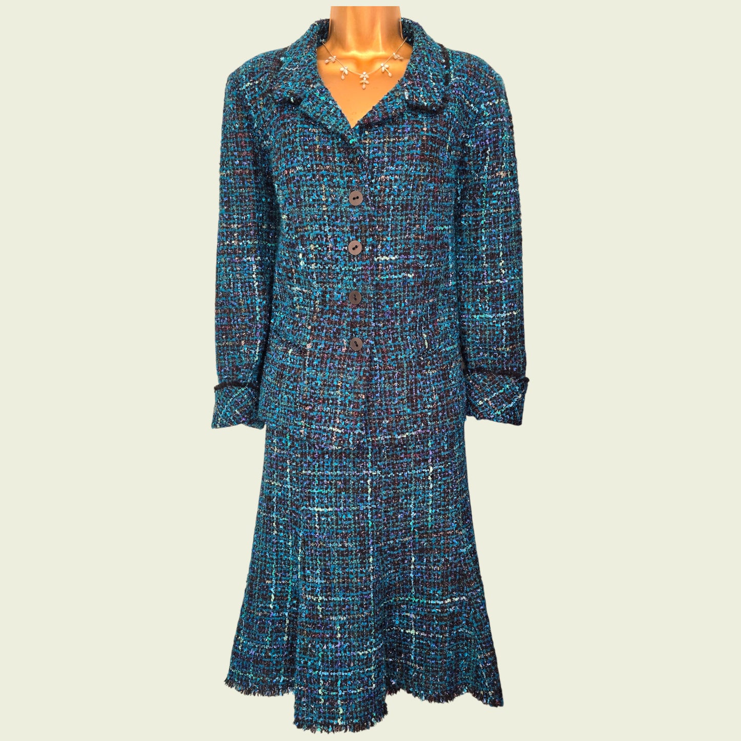 Blue patterned dress on a mannequin against a beige background