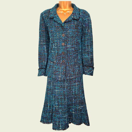 Blue patterned dress on a mannequin against a beige background