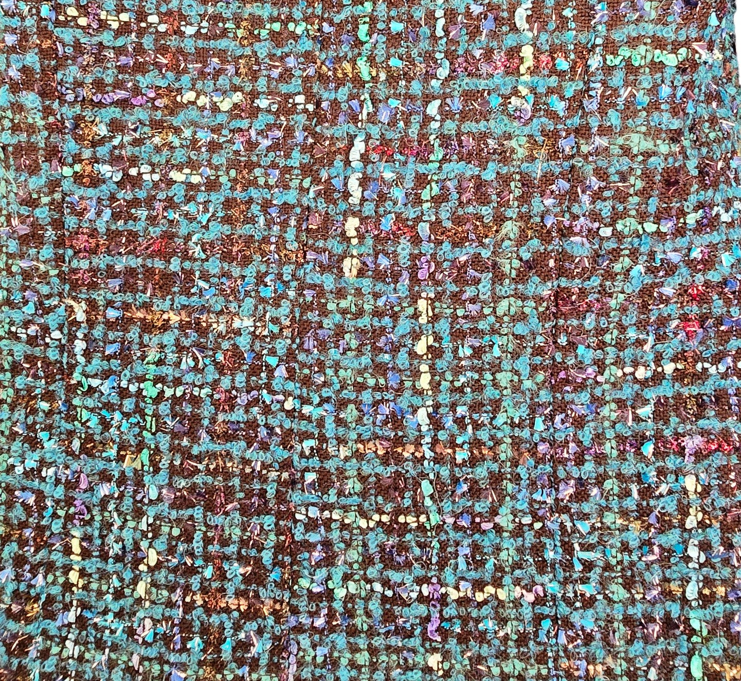 Close-up of a textured fabric with blue  pattern on a beige background