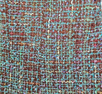 Close-up of a textured fabric with blue  pattern on a beige background