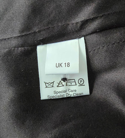 Label showing fabric details and care instructions on black background