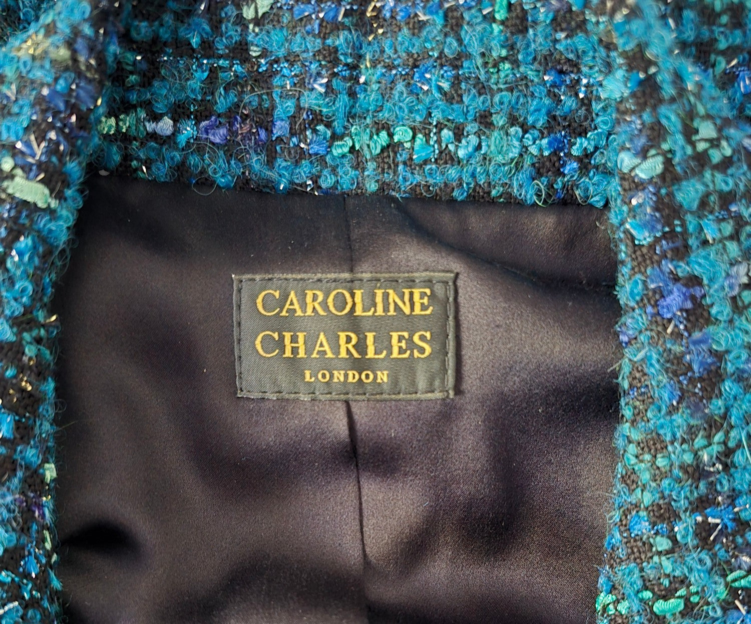 Caroline Charles label on black background
