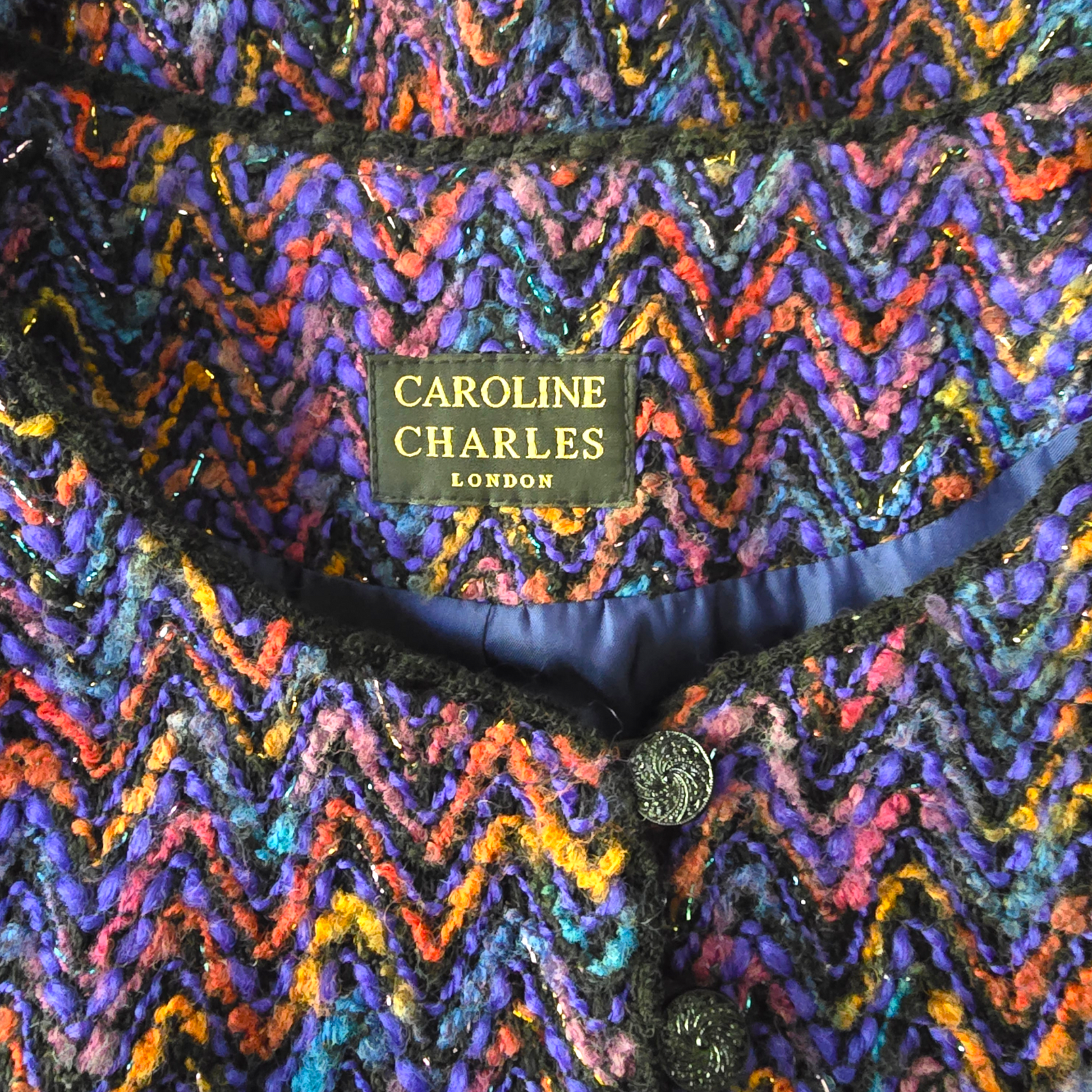 Multicolored zigzag patterned fabric with 'Caroline Charles London' label