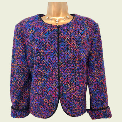 Multicolored patterned jacket on a mannequin against a plain background