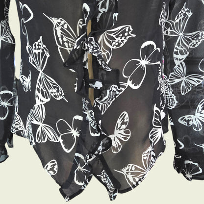 Black garment with white butterfly patterns on a beige background