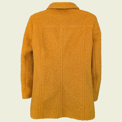 Mannequin wearing mustard coloured jacket on beige background