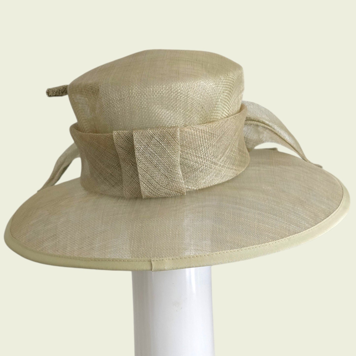 Beige straw hat with decorative band on a white background
