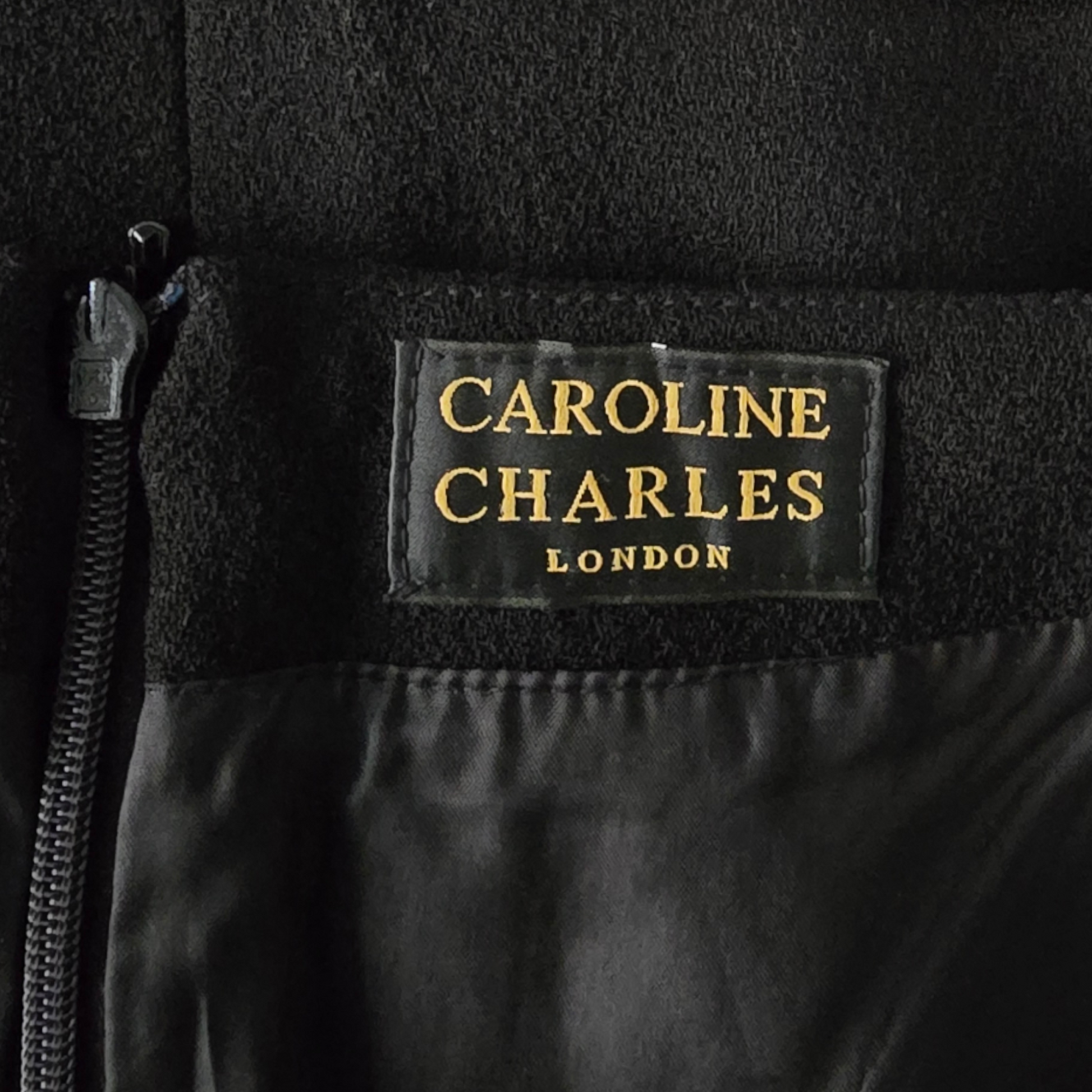 Black jacket with 'Caroline Charles London' label